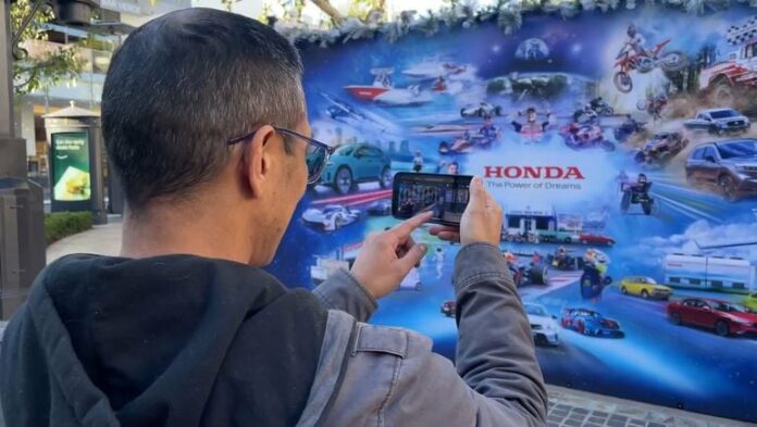 man with camera on mural wall backdrop