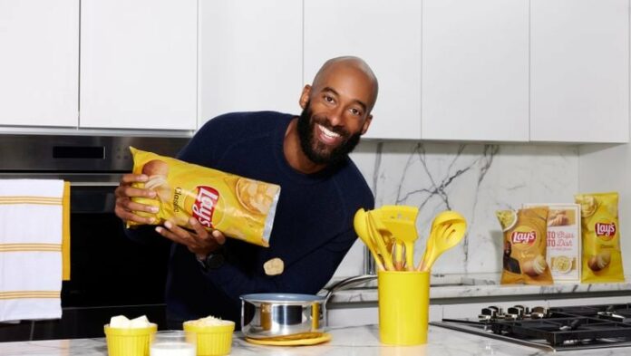 man pouring Lays chips